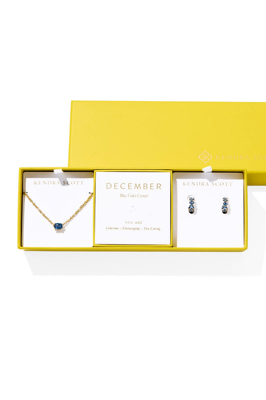 Jewelry set with necklace and earrings in a yellow box on a white background