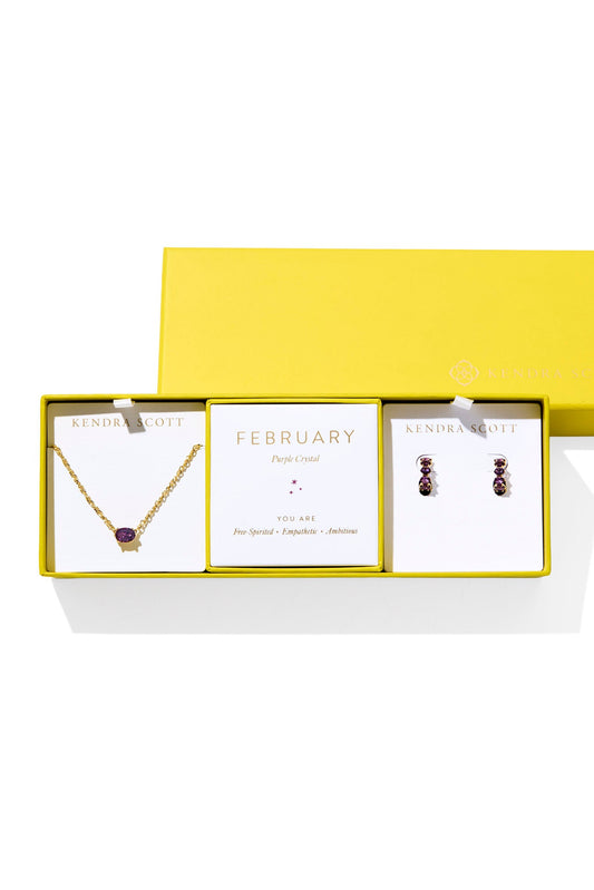 Jewelry set with necklace and earrings in a yellow box on a white background