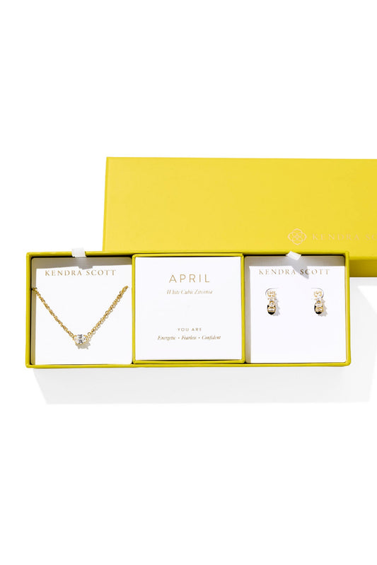 Jewelry set with necklace and earrings in a yellow box on a white background